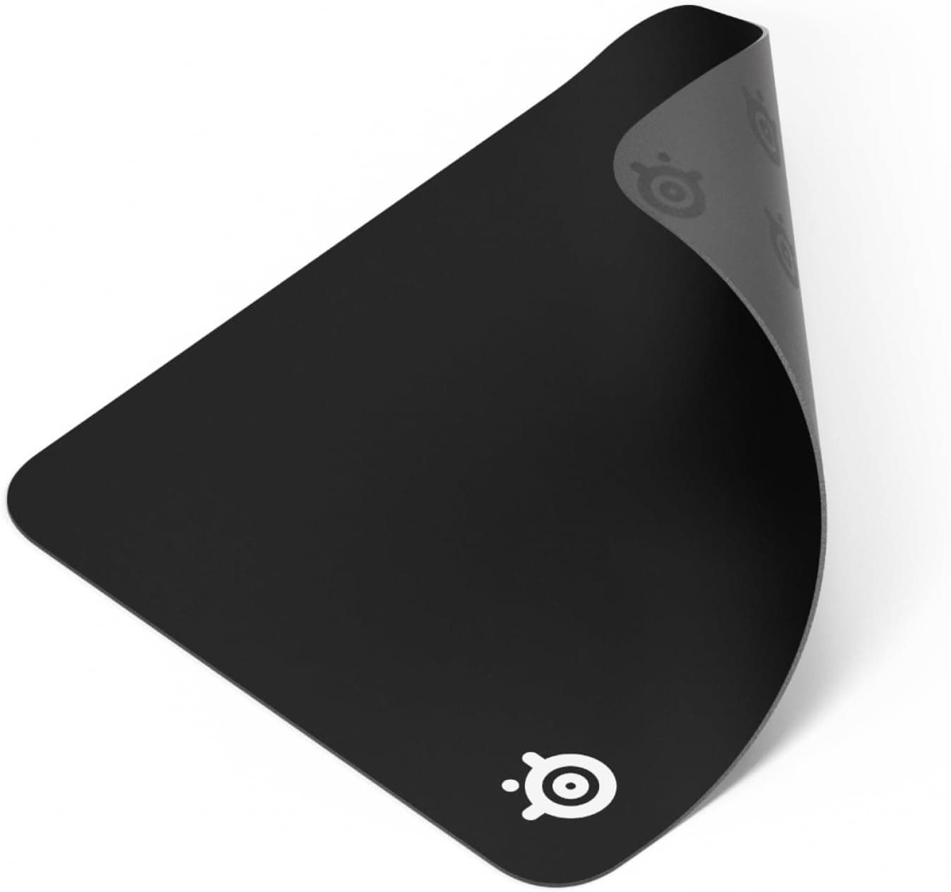 Black SteelSeries QcK medium cloth mouse pad with a curled corner showing its underside.