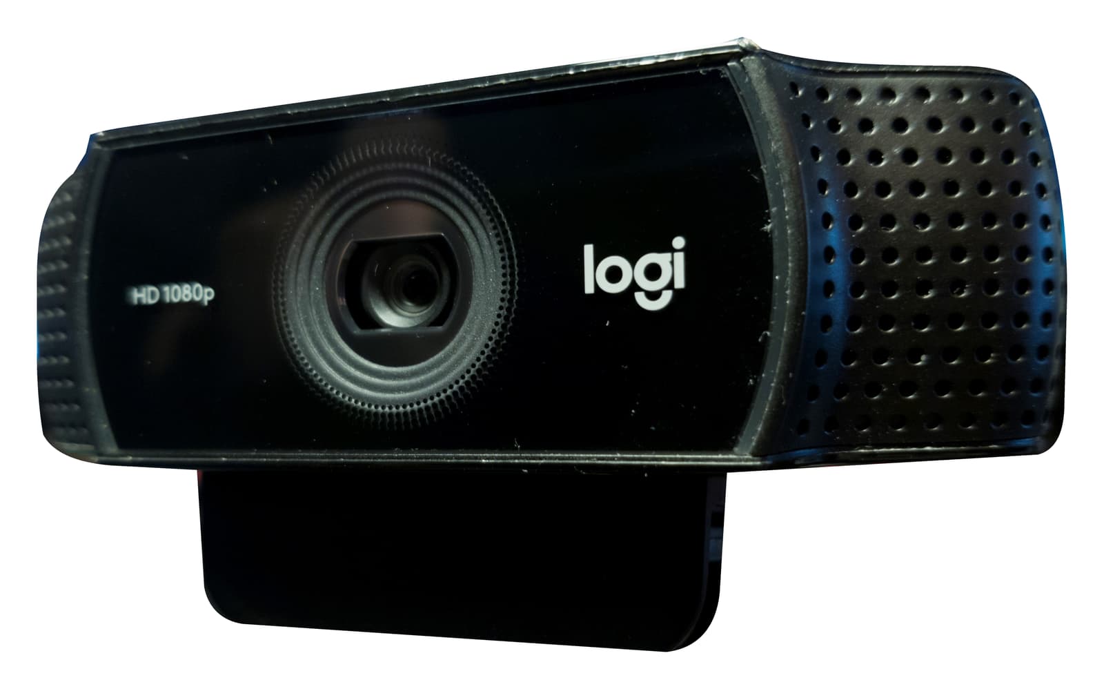 Black Logitech C920 webcam and its attached mounting clip isolated on a white background, showing the lens, microphone grilles, logi logo and HD 1080p marking.