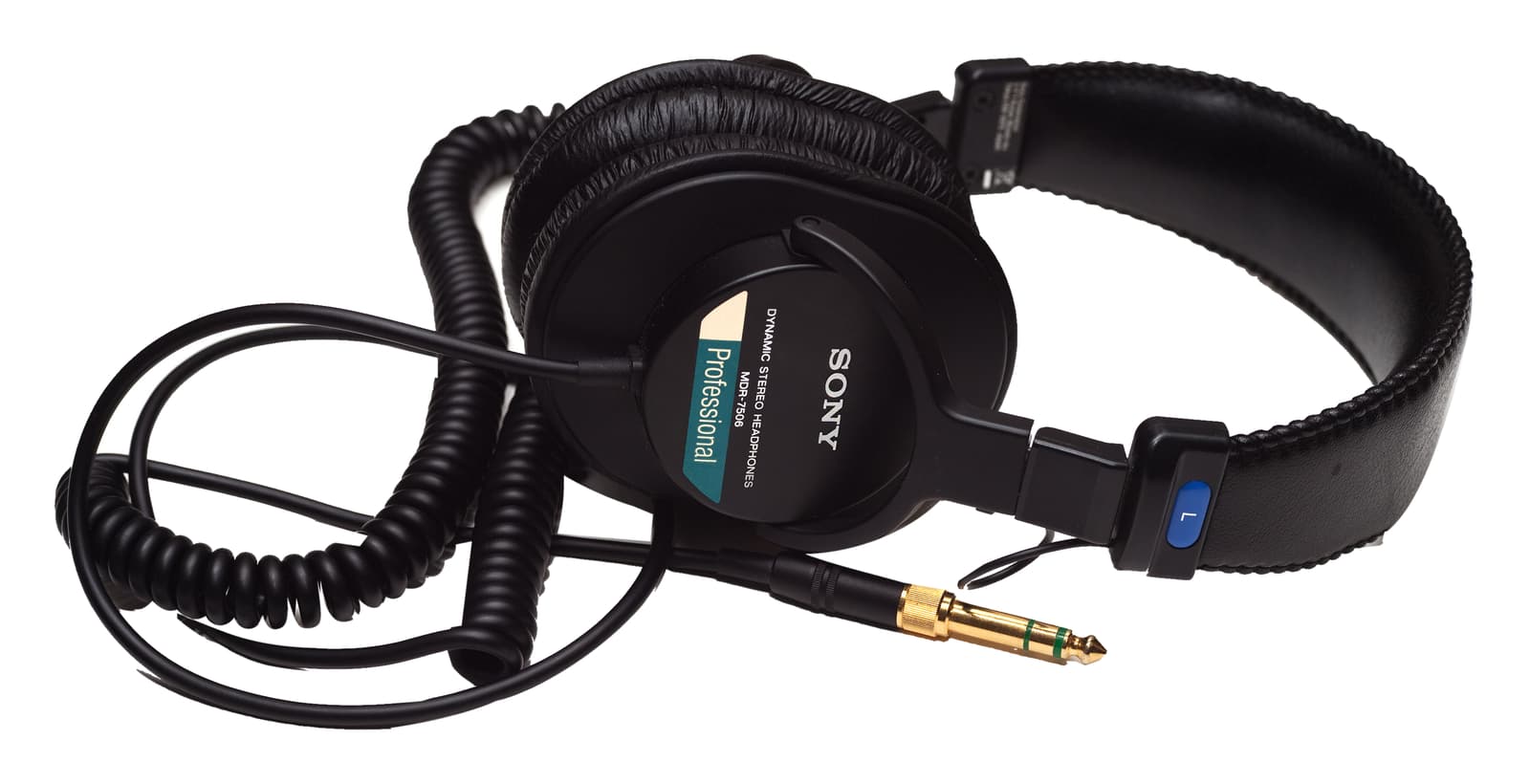 Black Sony MDR-7506 headphones isolated on white with their full coiled cable, cable loops and gold audio plug.