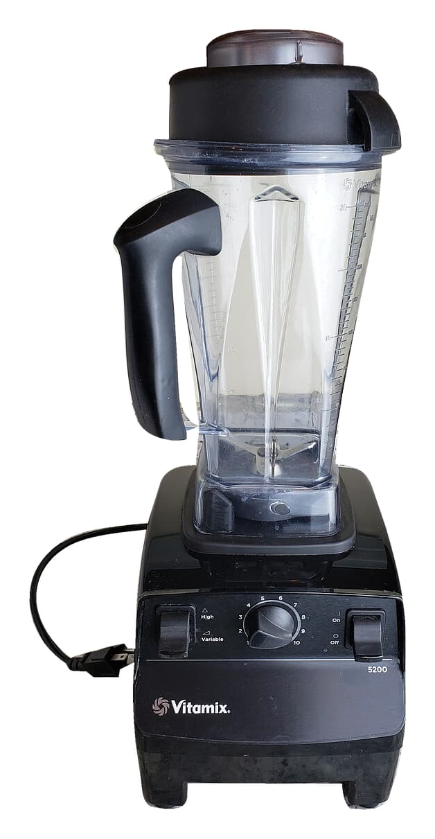 Black Vitamix 5200 blender with tall clear jar, manual dial, switches, power cord and plug against a white background.